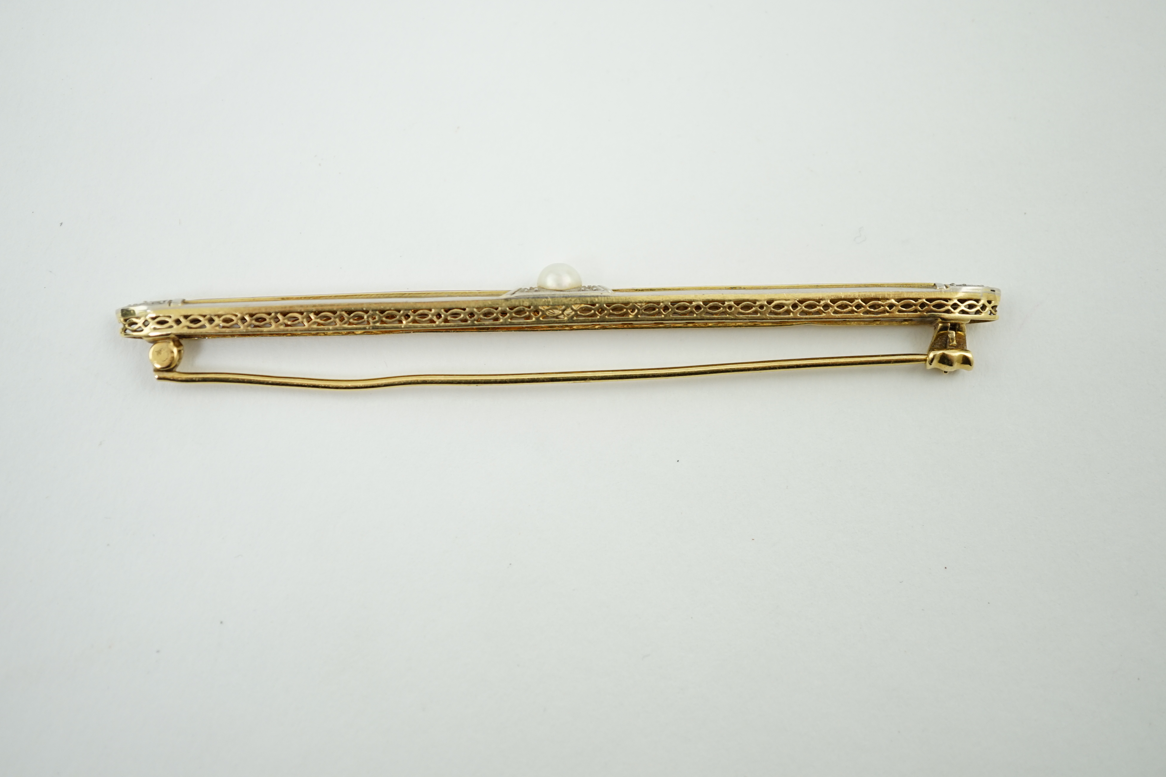 A 1940's 18ct gold, enamel, diamond chip and split pearl set bar brooch